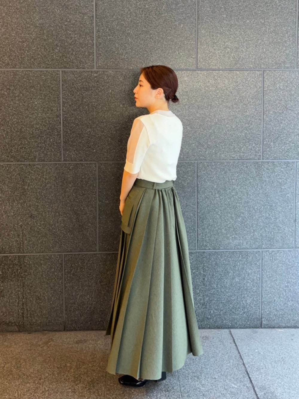 ホワイト系のニット/セーター、グリーン系のスカートを着用したレディースの夏コーディネートの2枚目の写真