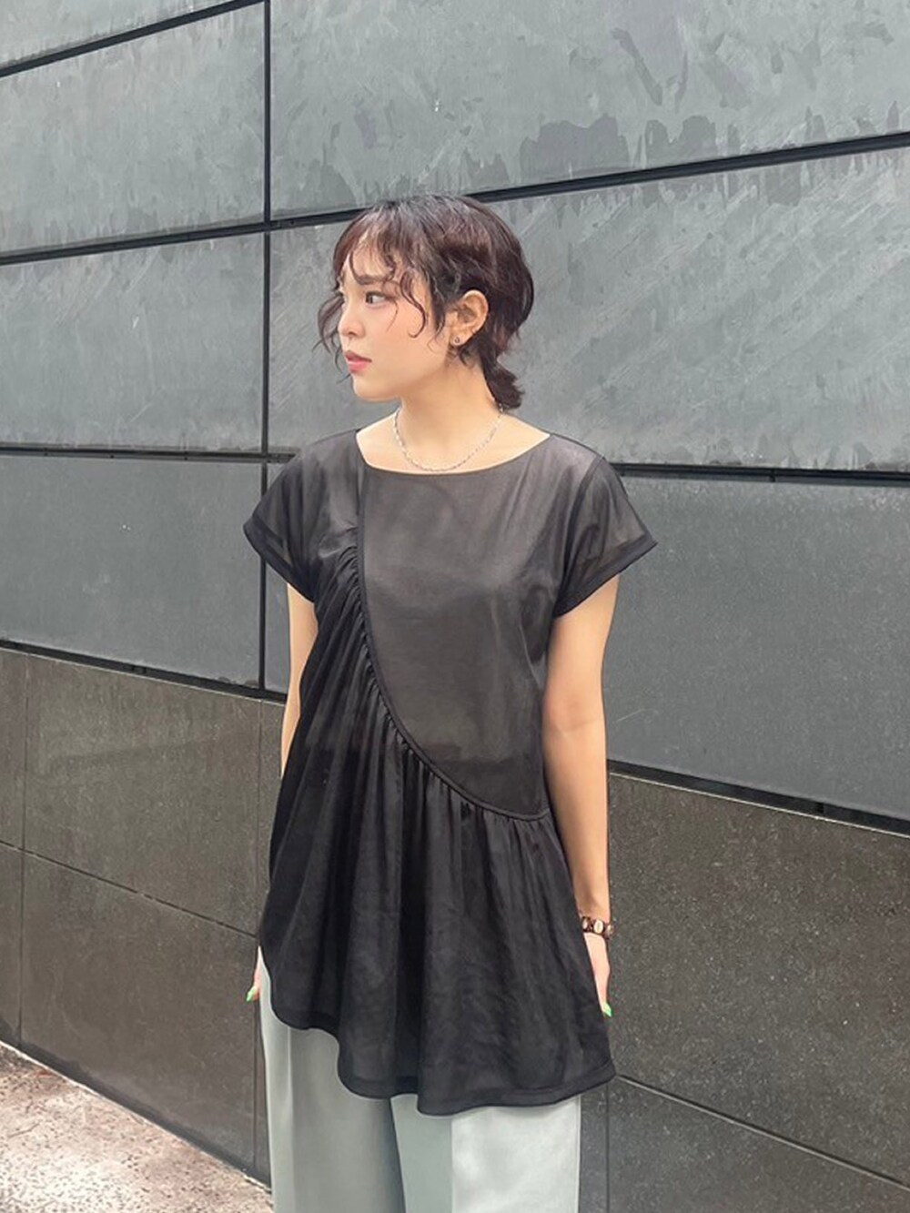 ブラック系のTシャツ/カットソー、グリーン系のスラックスを着用したレディースの夏コーディネートの4枚目の写真