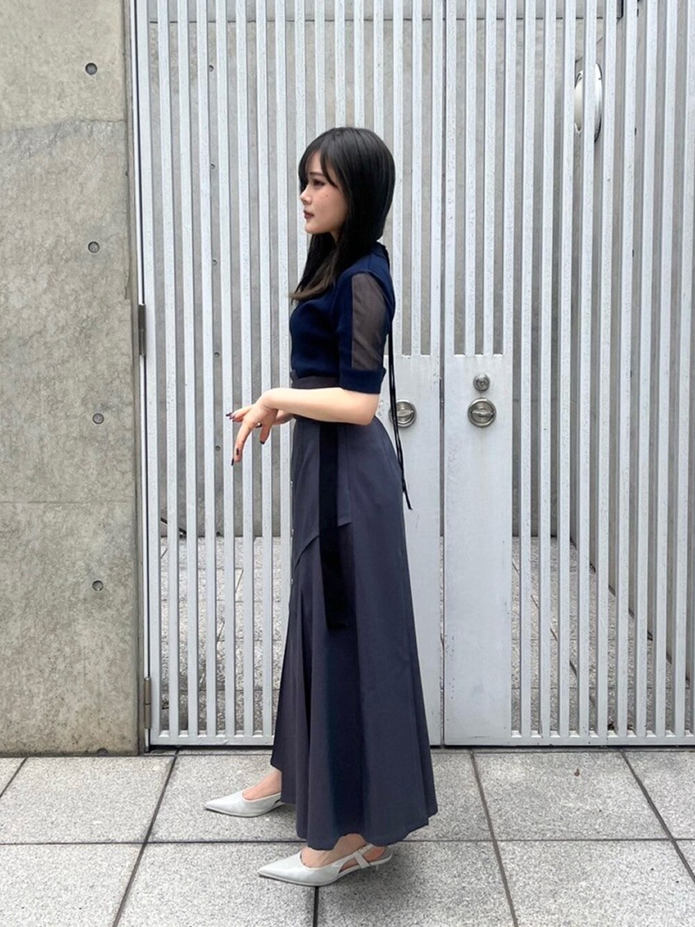 ブルー系のニット/セーターを着用したレディースの春コーディネートの2枚目の写真