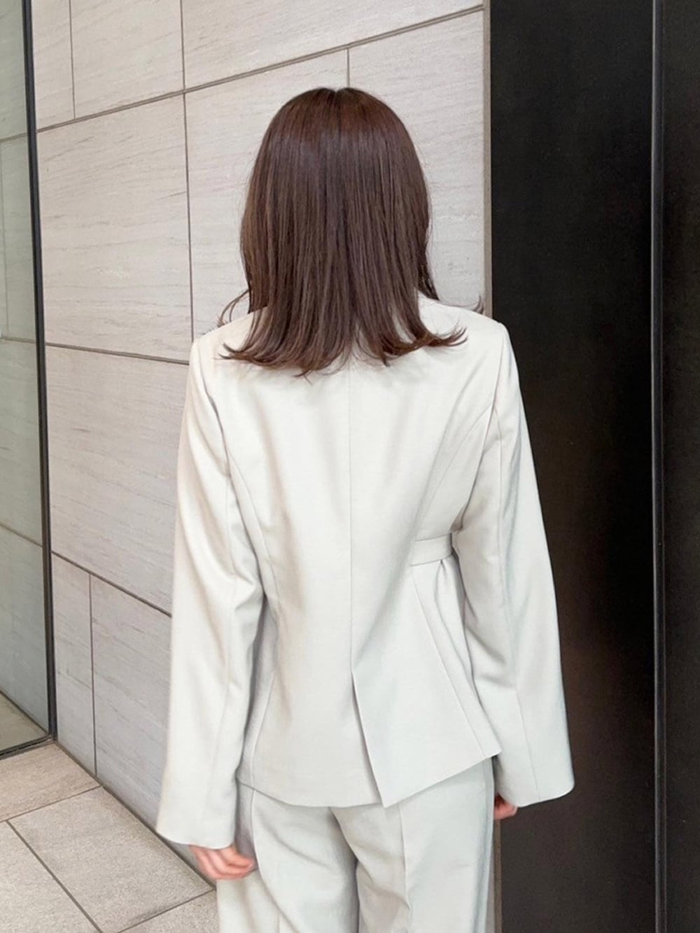 ベージュ系のセットアップ、ベージュ系のスラックスを着用したレディースの春コーディネートの7枚目の写真