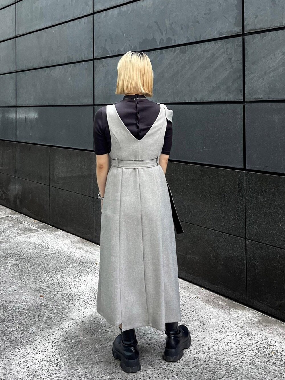 ブラウン系のTシャツ/カットソー、ブラック系のジャンパースカートを着用したレディースの秋コーディネートの3枚目の写真