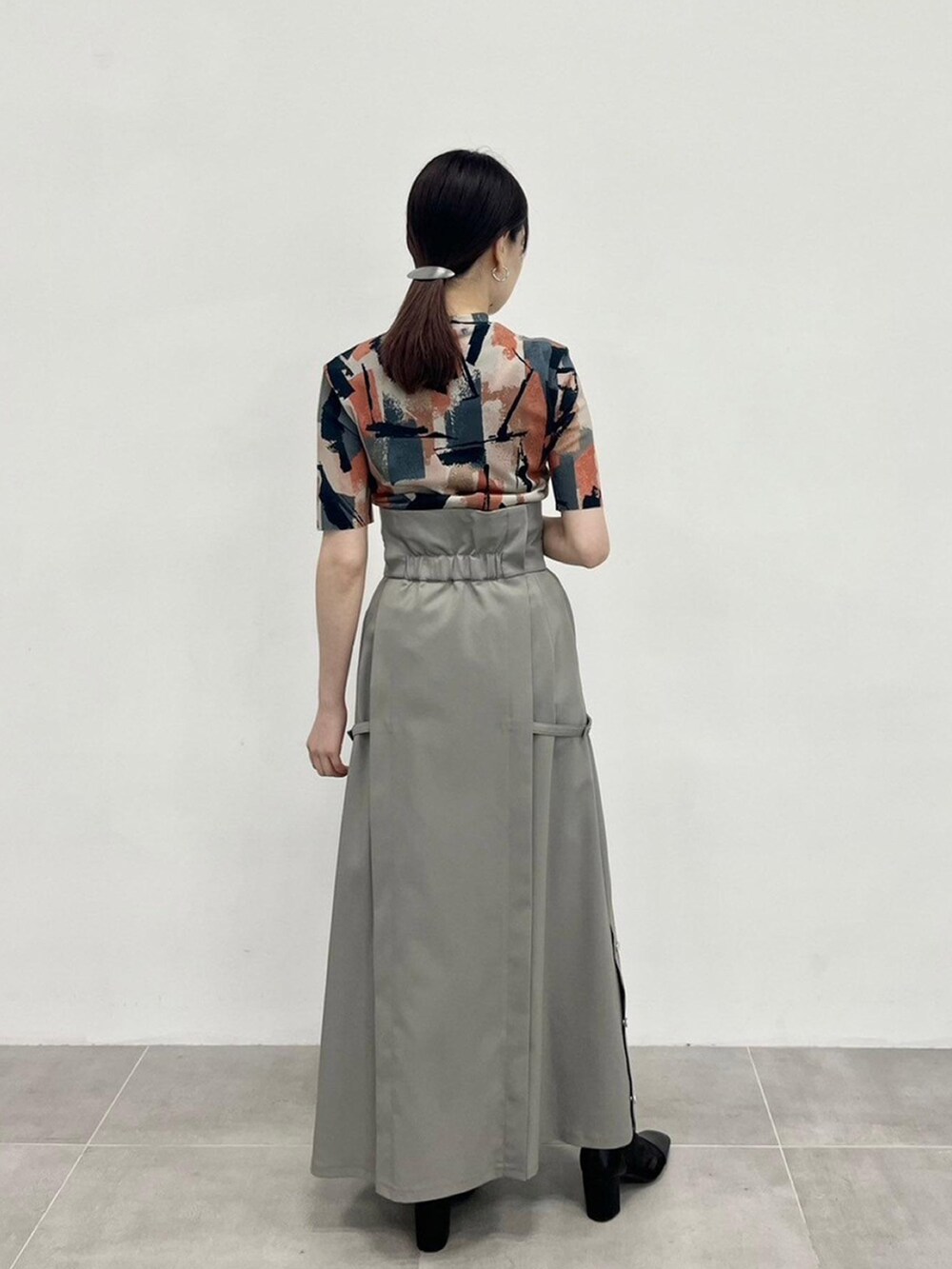 ベージュ系のTシャツ/カットソー、グレー系のスカートを着用したレディースの春コーディネートの5枚目の写真