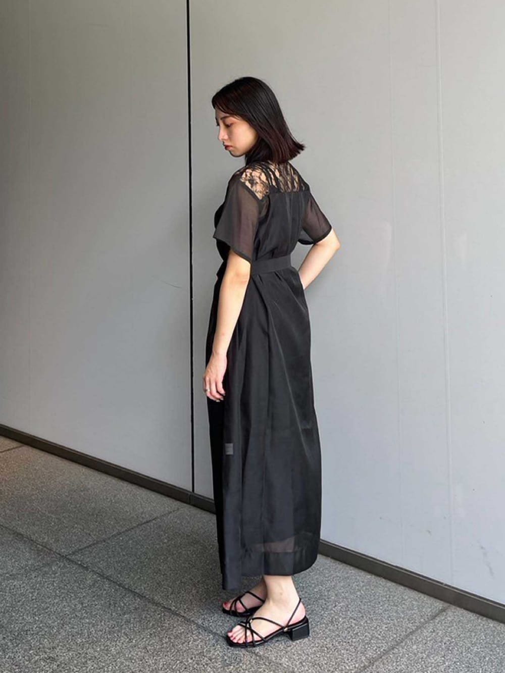 ブラック系のシャツワンピースを着用したレディースの夏コーディネートの2枚目の写真