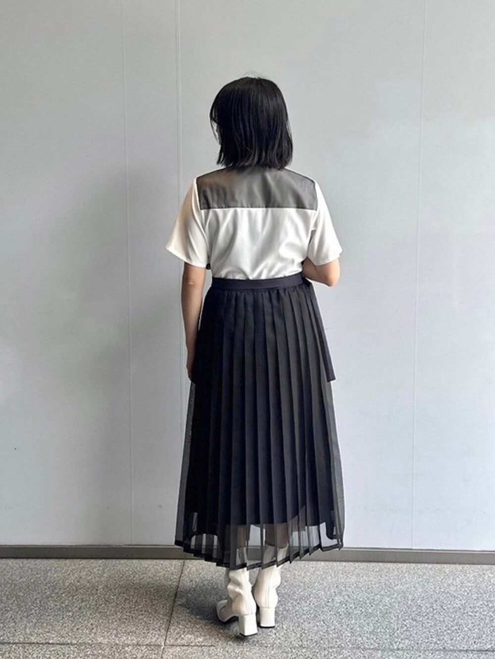 ブラック系のシャツワンピースを着用したレディースの春コーディネートの3枚目の写真