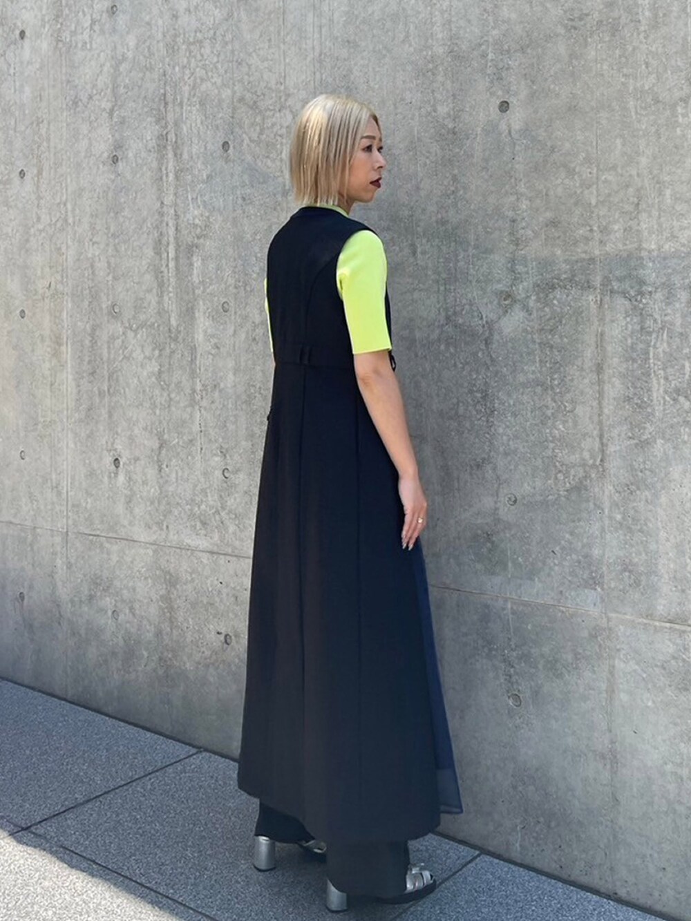 ブラック系のワンピース、グリーン系のニット/セーターを着用したレディースの夏コーディネートの2枚目の写真