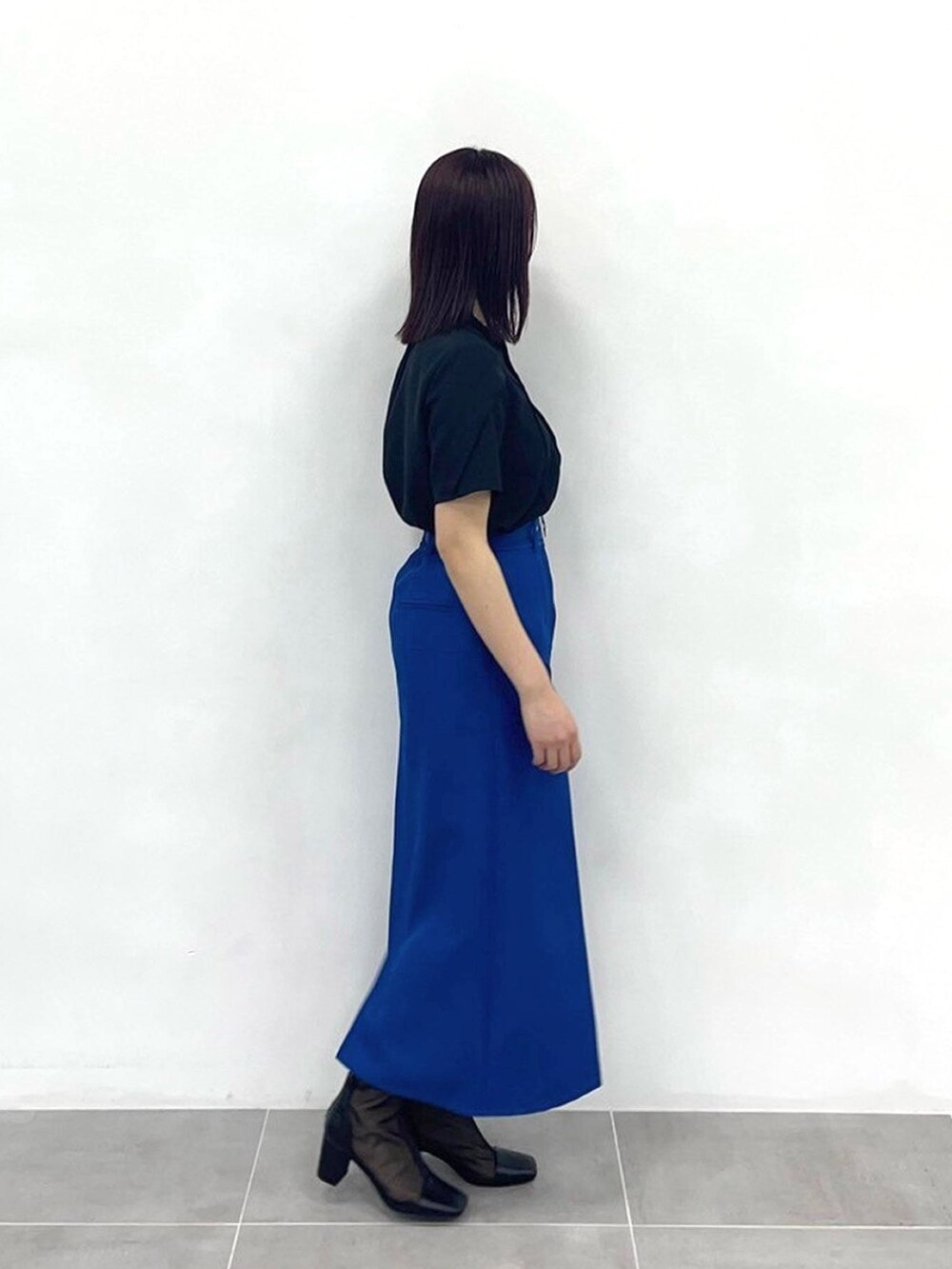 ブルー系のスカート、ブラック系のシャツ/ブラウスを着用したレディースの春コーディネートの4枚目の写真