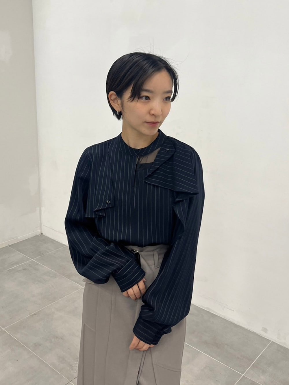 ブルー系のシャツ/ブラウス、グレー系のスカートを着用したレディースの秋コーディネートの4枚目の写真