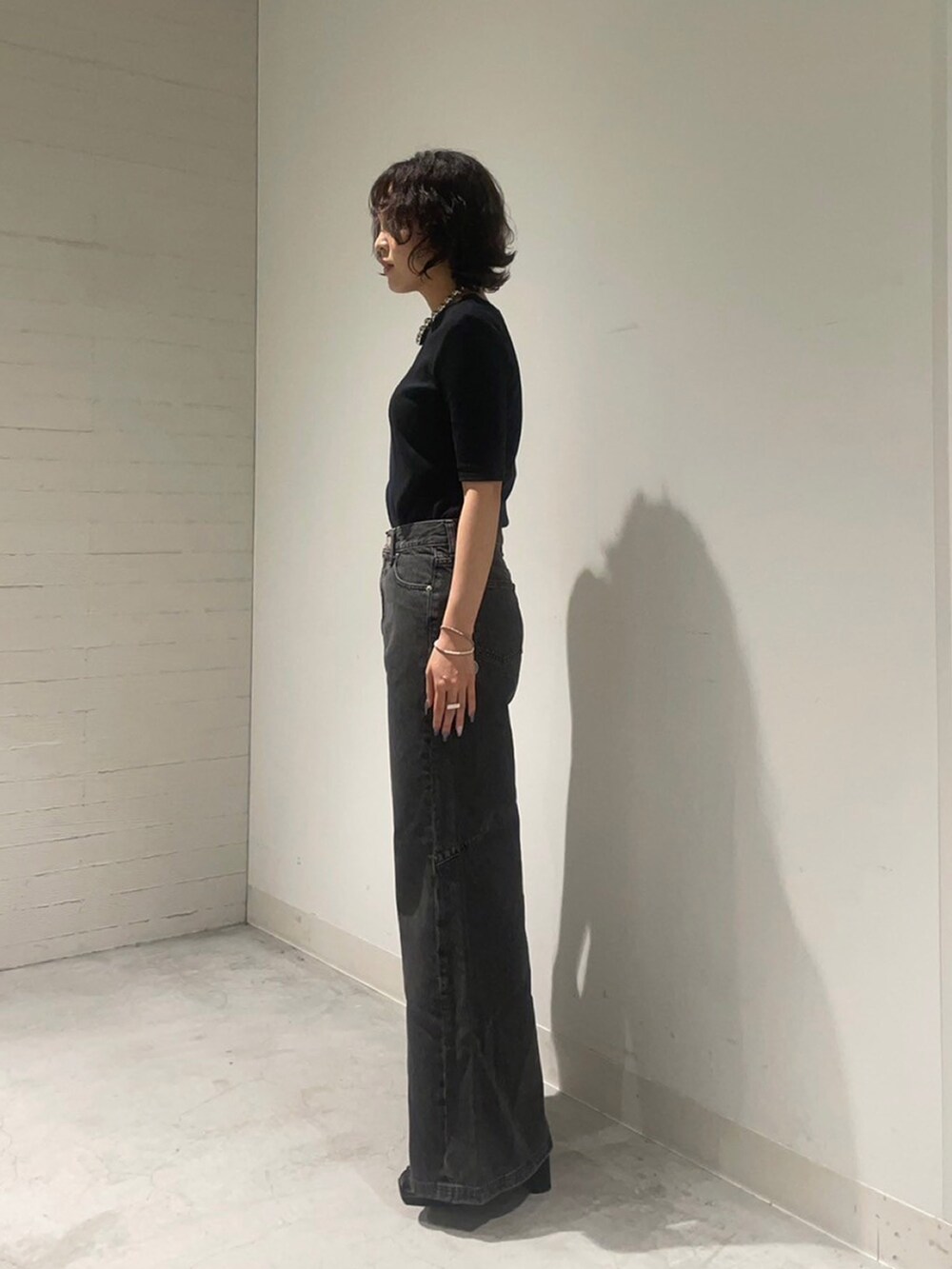 ブラック系のTシャツ/カットソー、ブラック系のデニムパンツを着用したレディースの夏コーディネートの2枚目の写真