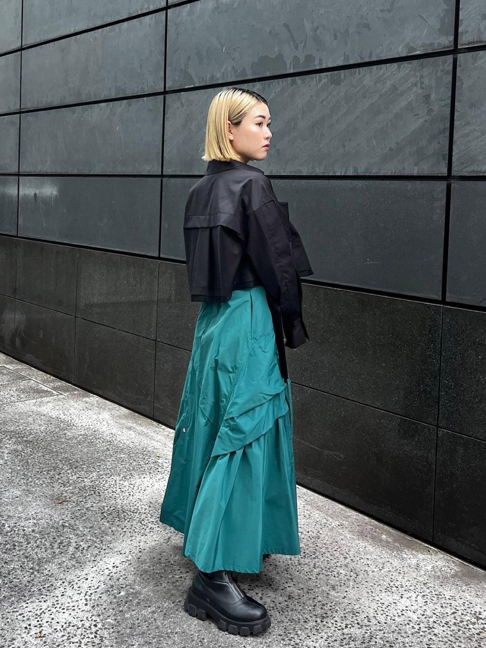 ブラック系のシャツ/ブラウス、グリーン系のスカートを着用したレディースの秋コーディネートの2枚目の写真