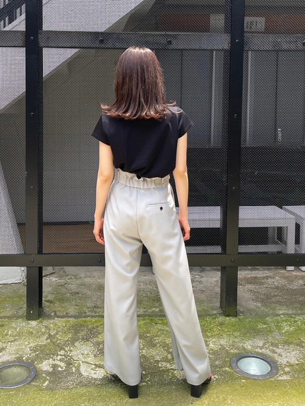 ブラック系のTシャツ/カットソー、グレー系のその他パンツを着用したレディースの春コーディネートの3枚目の写真