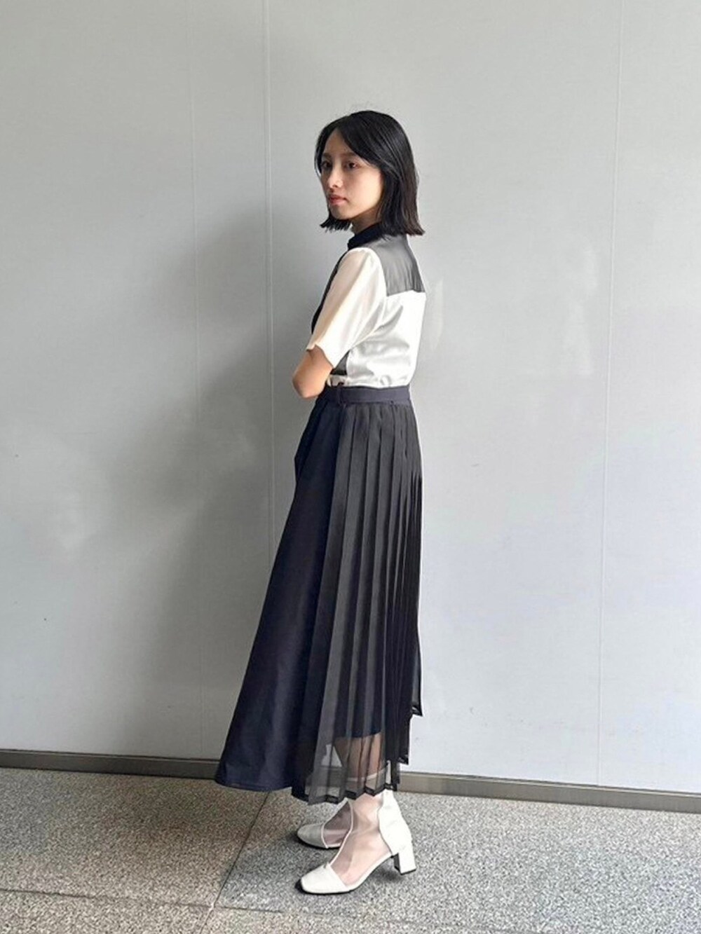 ブラック系のシャツワンピースを着用したレディースの春コーディネートの2枚目の写真