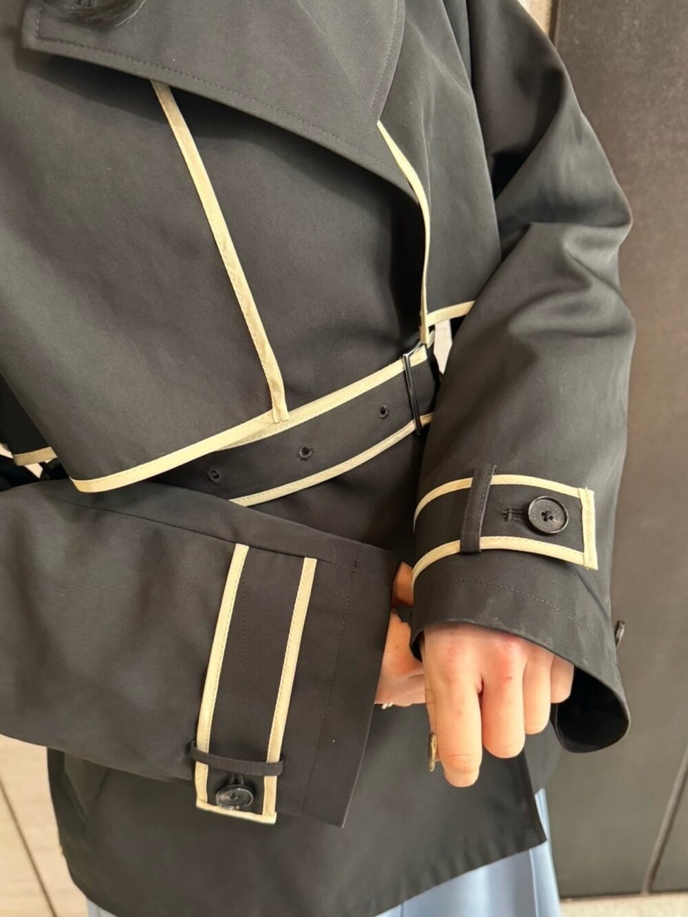 ブラック系のトレンチコートを着用したレディースの春コーディネートの7枚目の写真