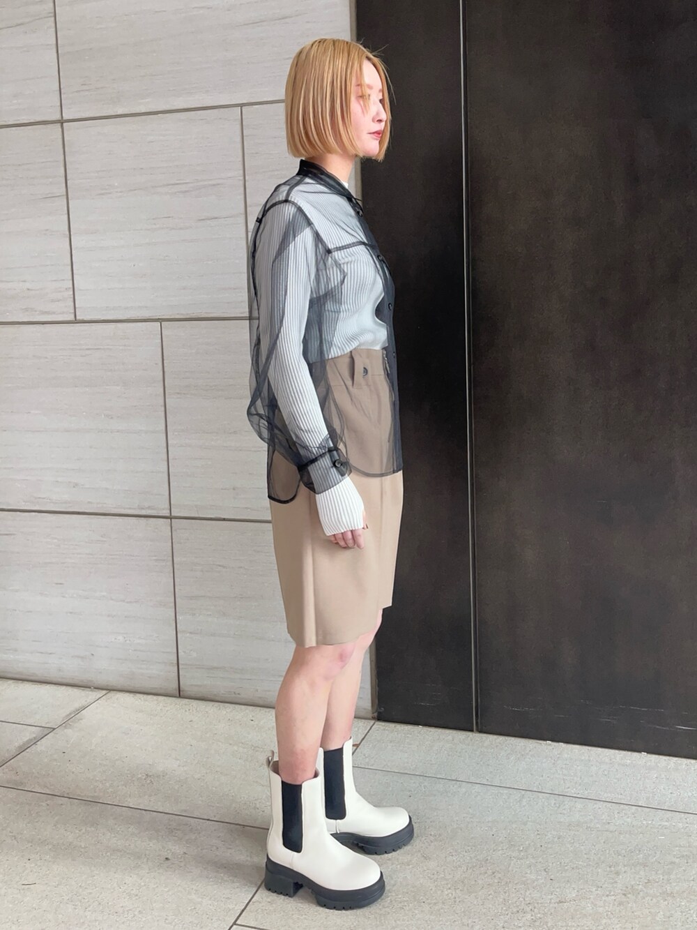 ブラック系のシャツ/ブラウス、ホワイト系のニット/セーター、ベージュ系のその他パンツを着用したレディースの春コーディネートの4枚目の写真