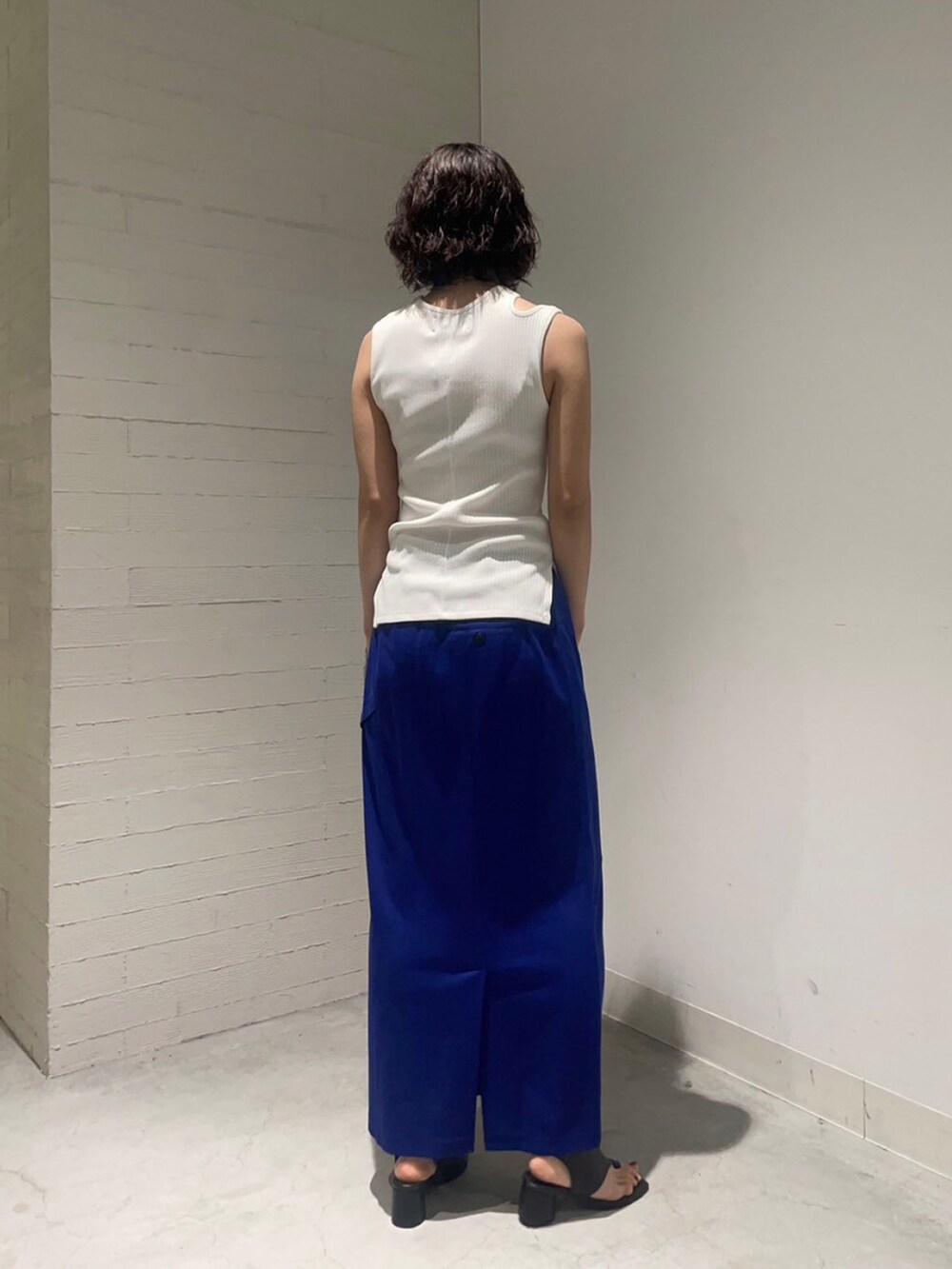 ホワイト系のタンクトップ、ブルー系のスカートを着用したレディースの夏コーディネートの3枚目の写真