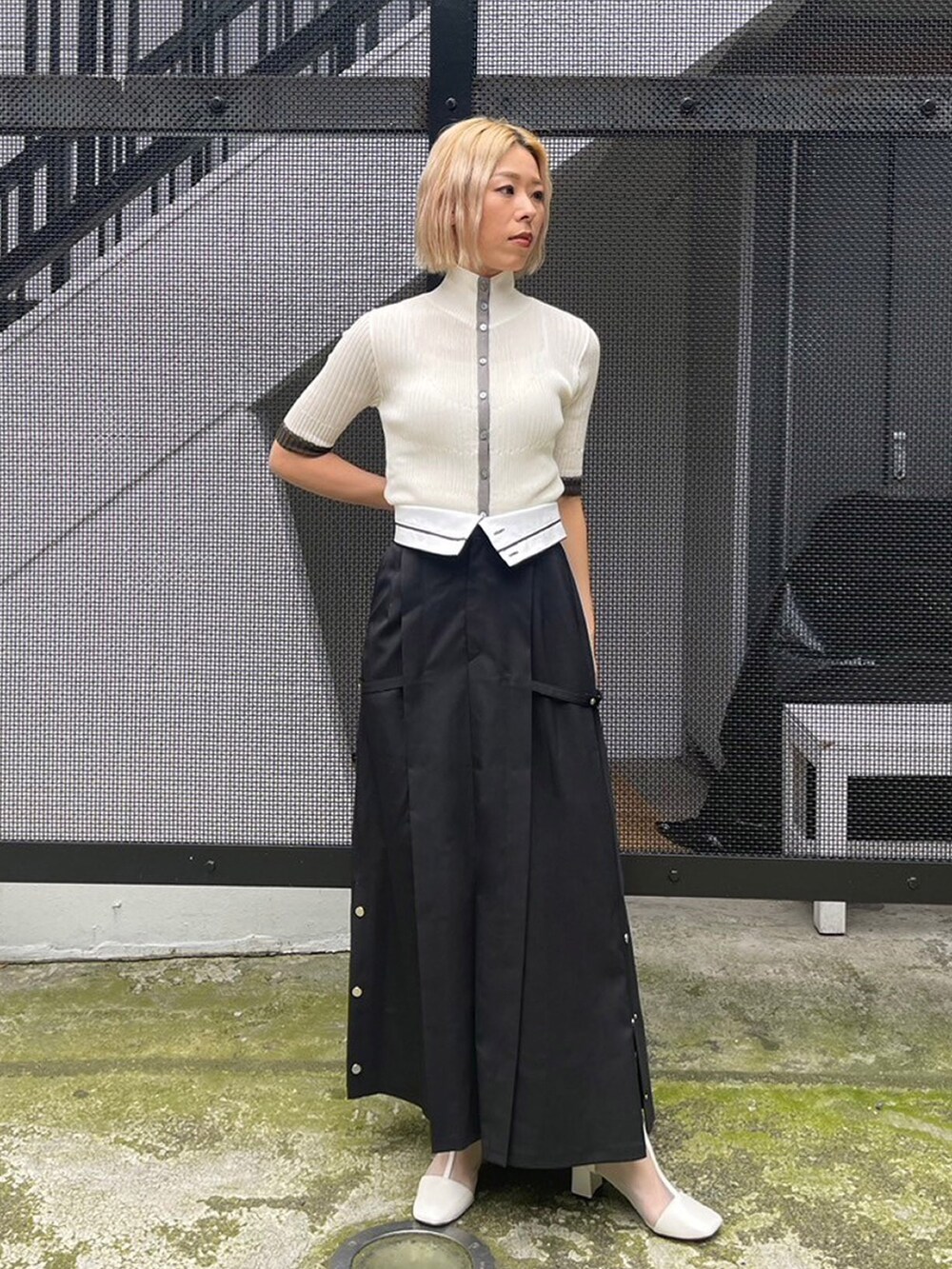 ホワイト系のニット/セーター、ブラック系のスカートを着用したレディースの夏コーディネートの4枚目の写真