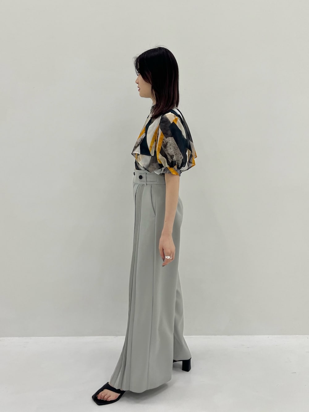 イエロー系のシャツ/ブラウス、グレー系のその他パンツを着用したレディースの春コーディネートの3枚目の写真