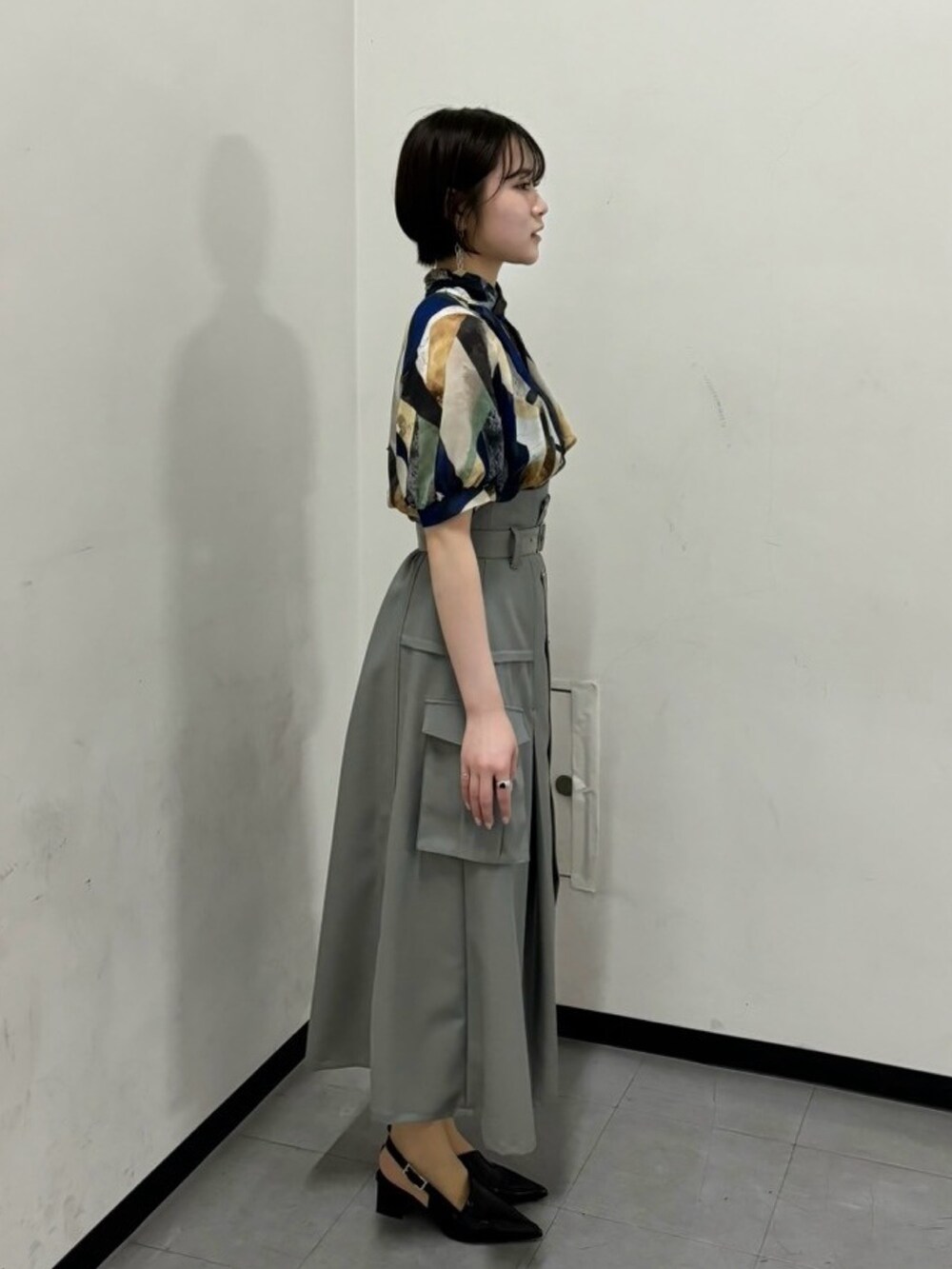 ブルー系のシャツ/ブラウス、グレー系のスカートを着用したレディースの春コーディネートの4枚目の写真