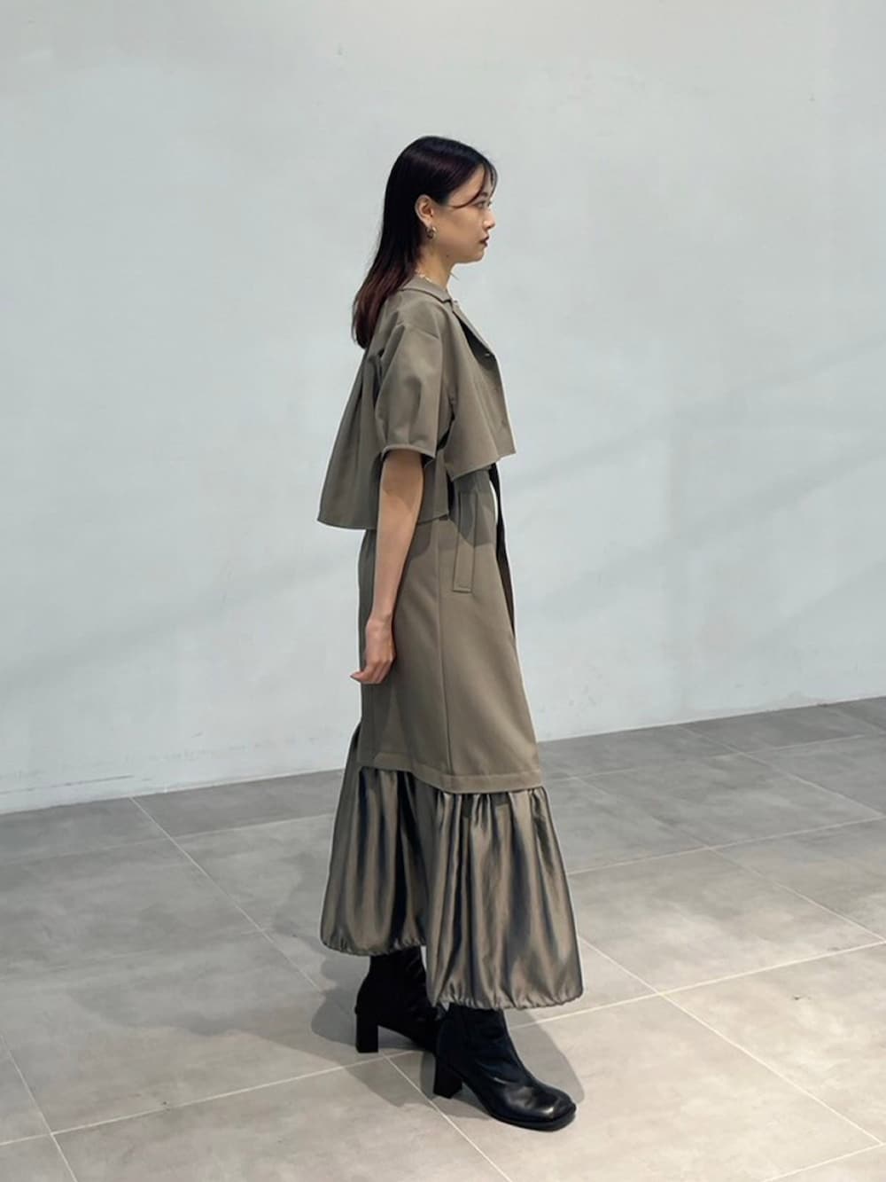 グリーン系のワンピースを着用したレディースの秋コーディネートの2枚目の写真