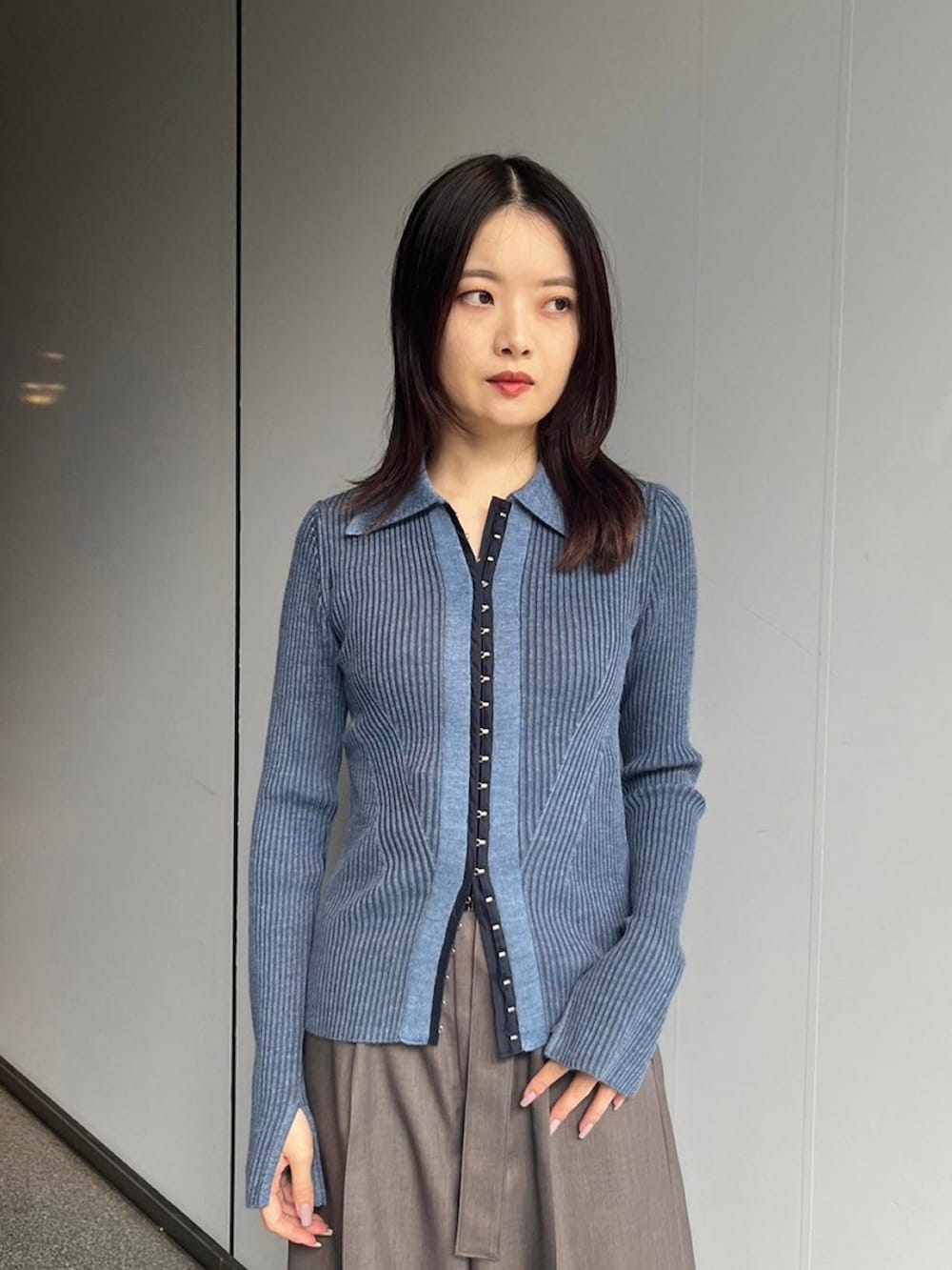 ブルー系のニット/セーター、ブラウン系のその他パンツを着用したレディースの秋コーディネートの3枚目の写真