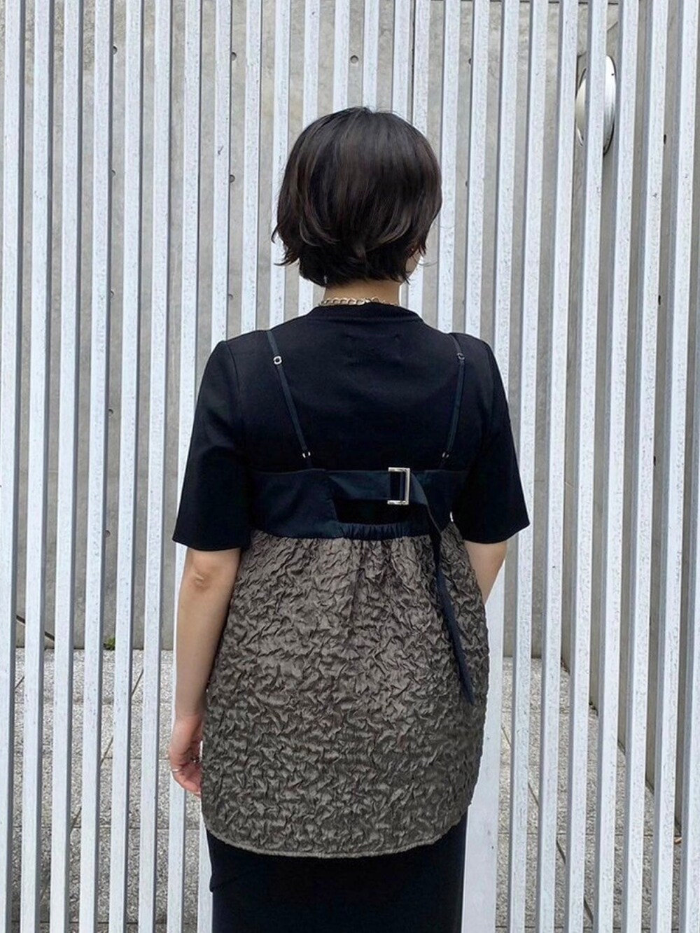 グリーン系のキャミソールを着用したレディースの春コーディネートの6枚目の写真