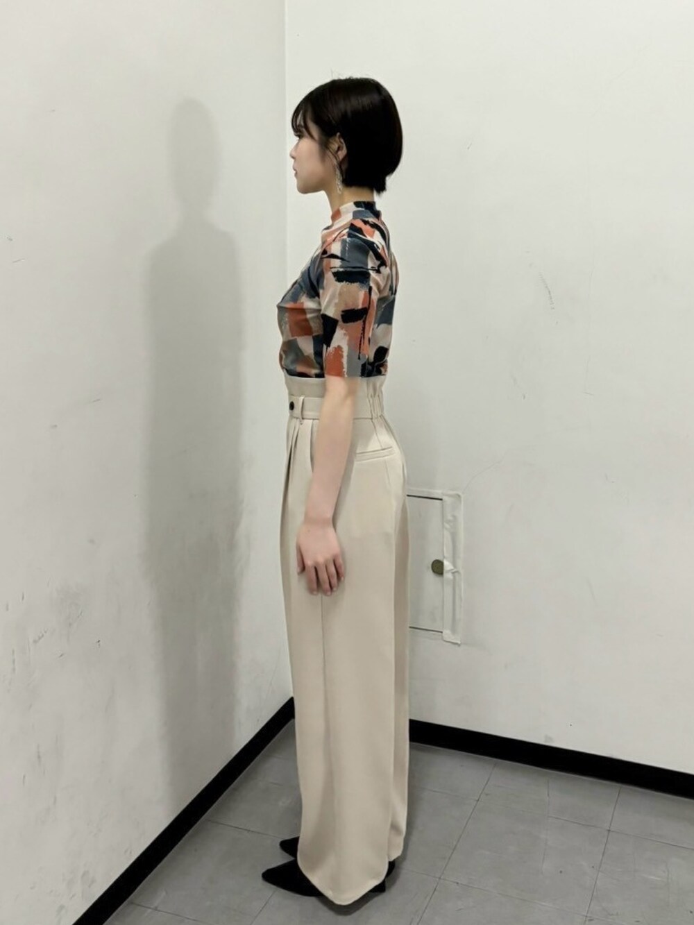 ベージュ系のTシャツ/カットソー、ベージュ系のスラックスを着用したレディースの春コーディネートの2枚目の写真