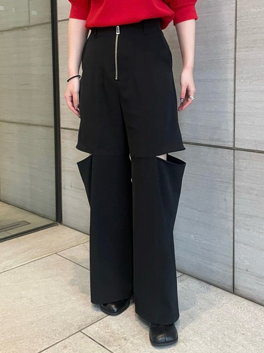 レッド系のニット/セーター、ブラック系のその他パンツを着用したレディースの春コーディネートの5枚目の写真