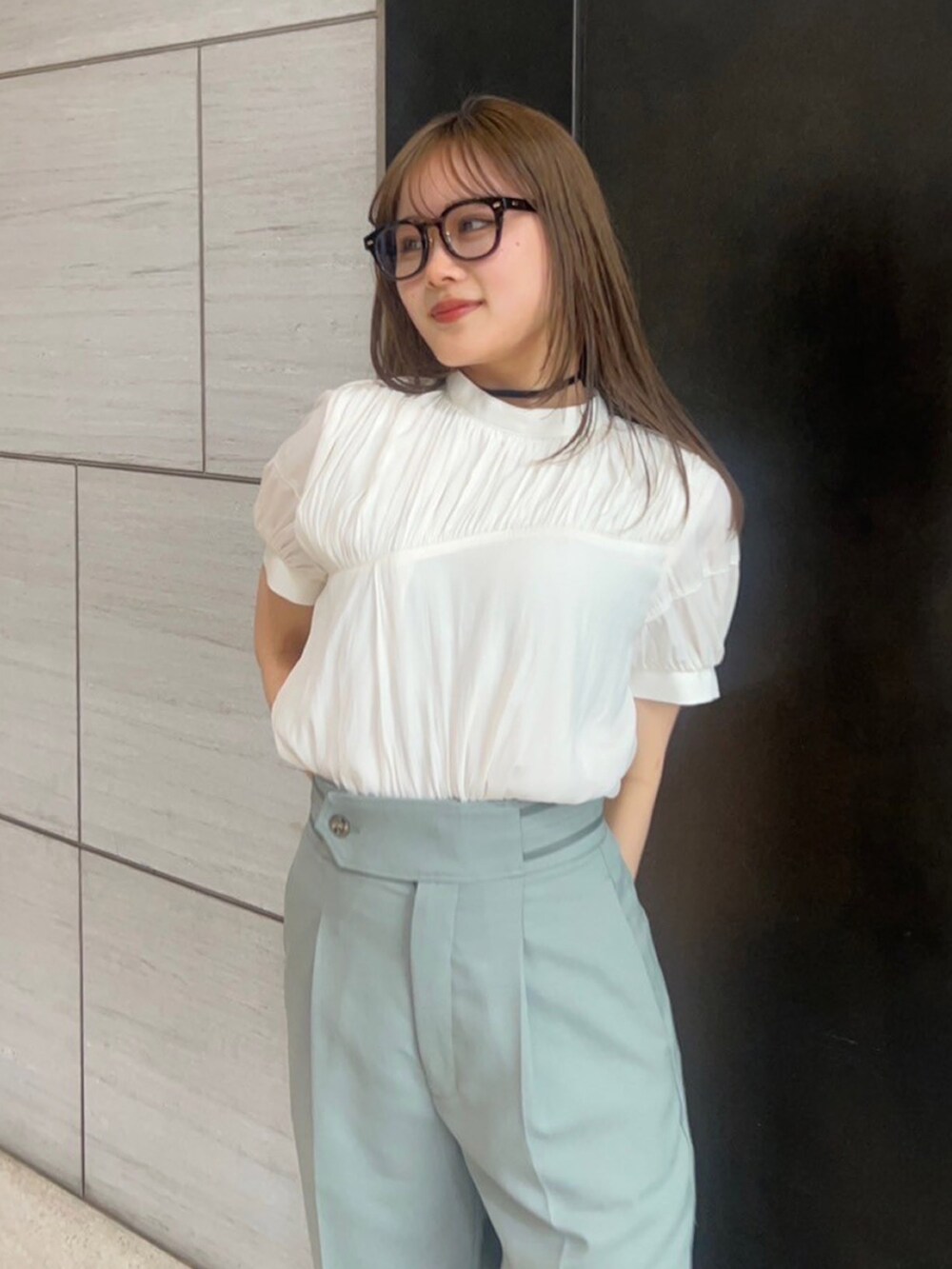 ベージュ系のシャツ/ブラウス、グリーン系のスラックスを着用したレディースの春コーディネートの5枚目の写真