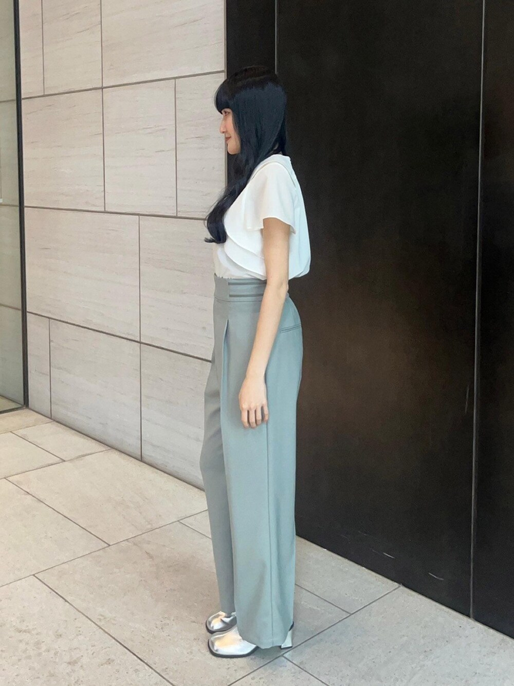 ホワイト系のシャツ/ブラウス、グリーン系のスラックスを着用したレディースの春コーディネートの2枚目の写真