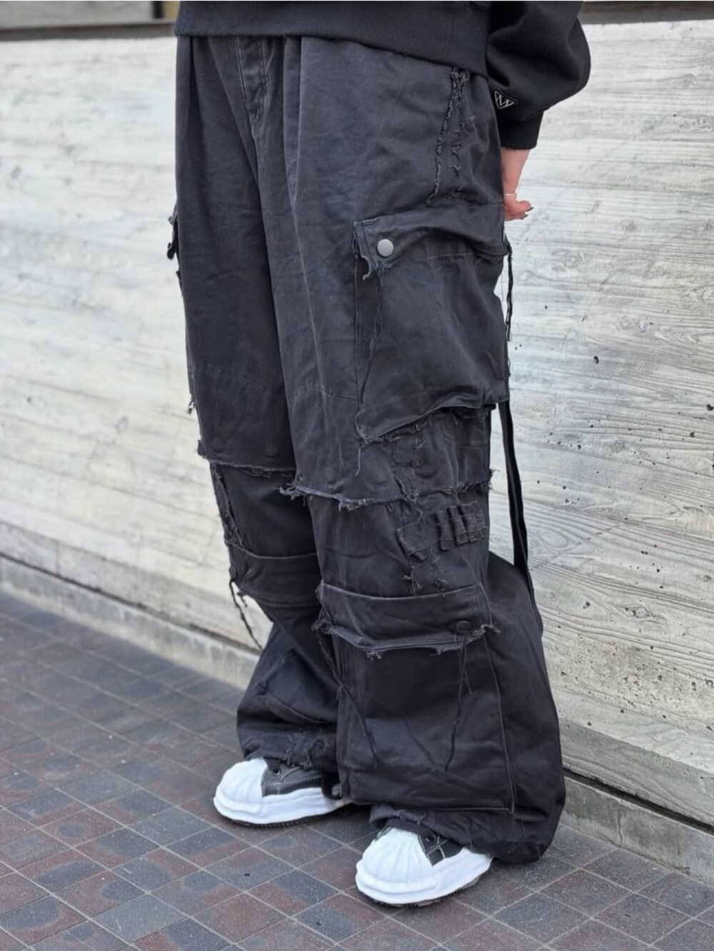 ブラック系のスニーカー、ブラック系のパンツ、ブラック系のパーカーを着用したレディースの秋コーディネートの3枚目の写真