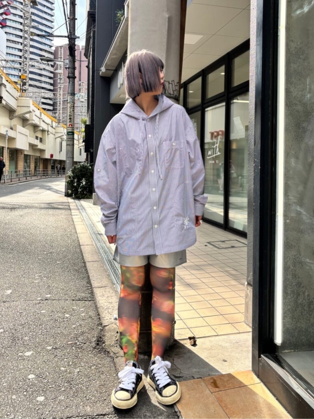 ブラック系のスニーカー、ブルー系のシャツ/ブラウスを着用したレディースの春コーディネートの2枚目の写真