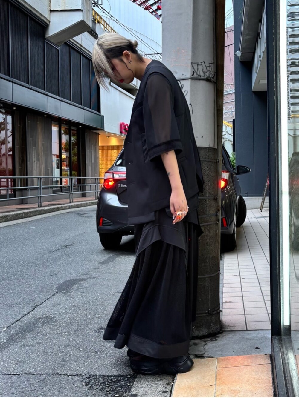 ブラック系のベスト、ブラック系のTシャツ/カットソー、ブラック系のスカートを着用したレディースの夏コーディネートの2枚目の写真