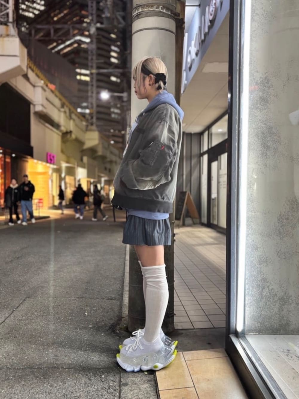 ブルー系のパーカー、ブラック系のジャケット/アウター、ホワイト系のシューズを着用したレディースの冬コーディネートの2枚目の写真