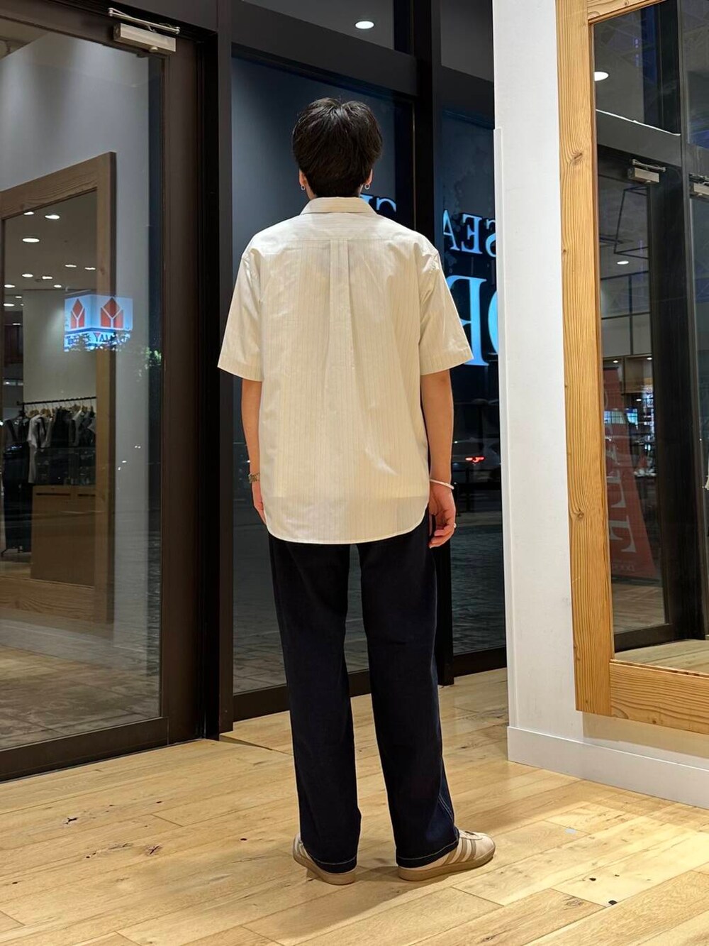 ホワイト系のTシャツ/カットソー、ベージュ系のシャツ/ブラウス、ブルー系のデニムパンツを着用したメンズの夏コーディネートの3枚目の写真