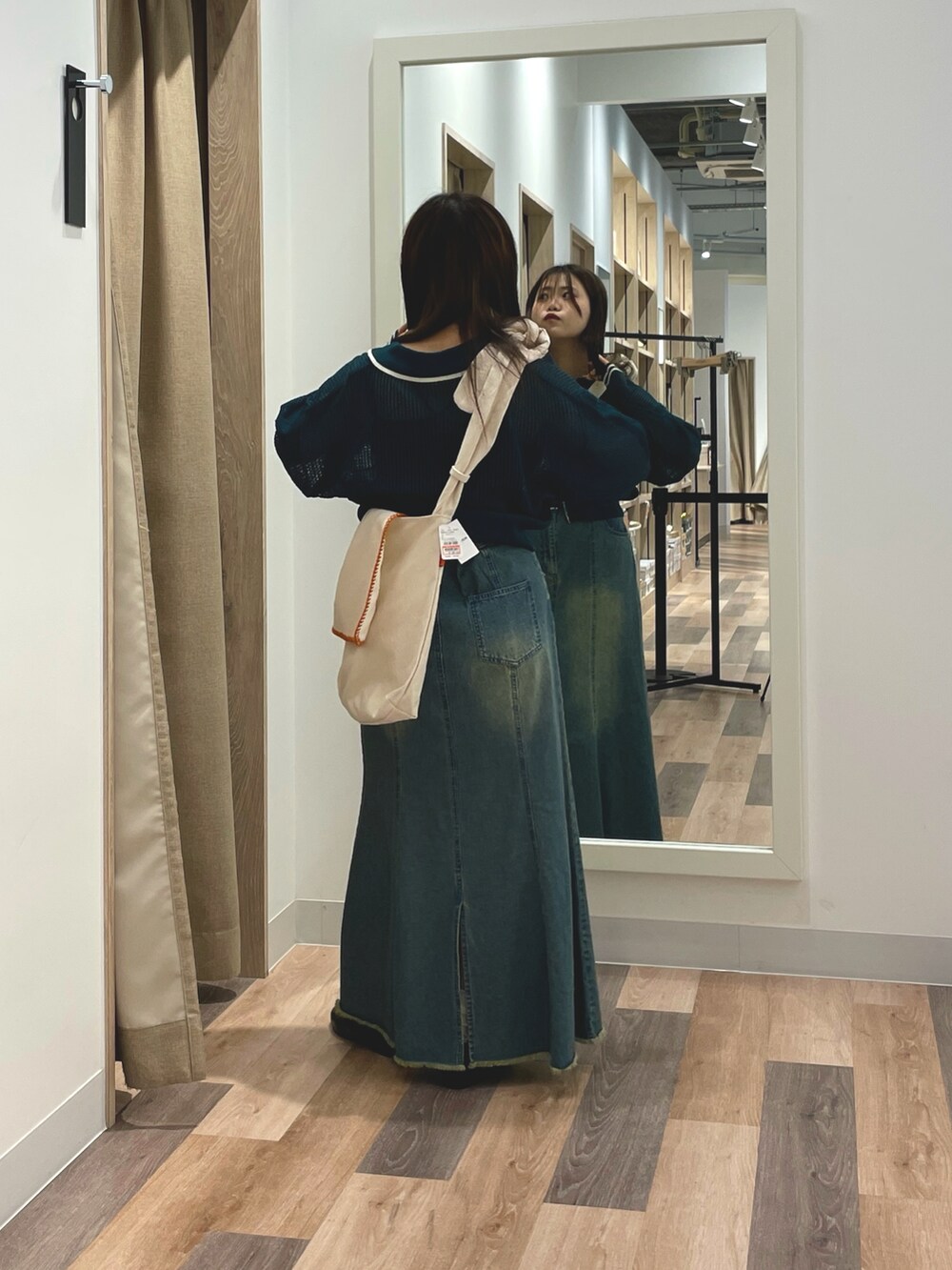 ブルー系のスカート、グリーン系のカーディガン/ボレロ、ホワイト系のショルダーバッグを着用したレディースの夏コーディネートの3枚目の写真