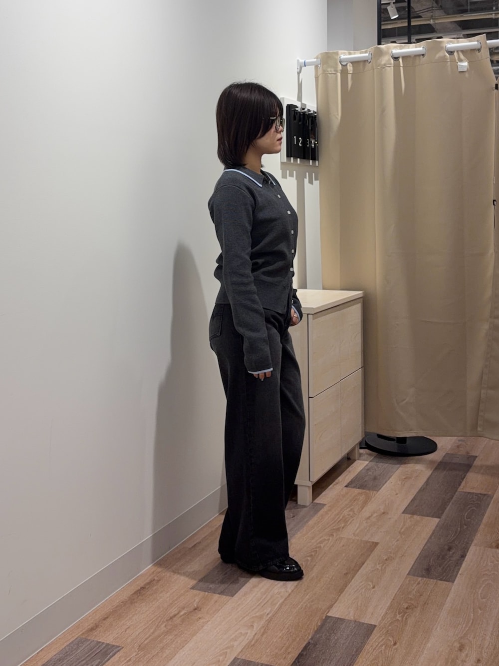 グレー系のカーディガン/ボレロ、ブラック系のデニムパンツを着用したレディースの春コーディネートの2枚目の写真