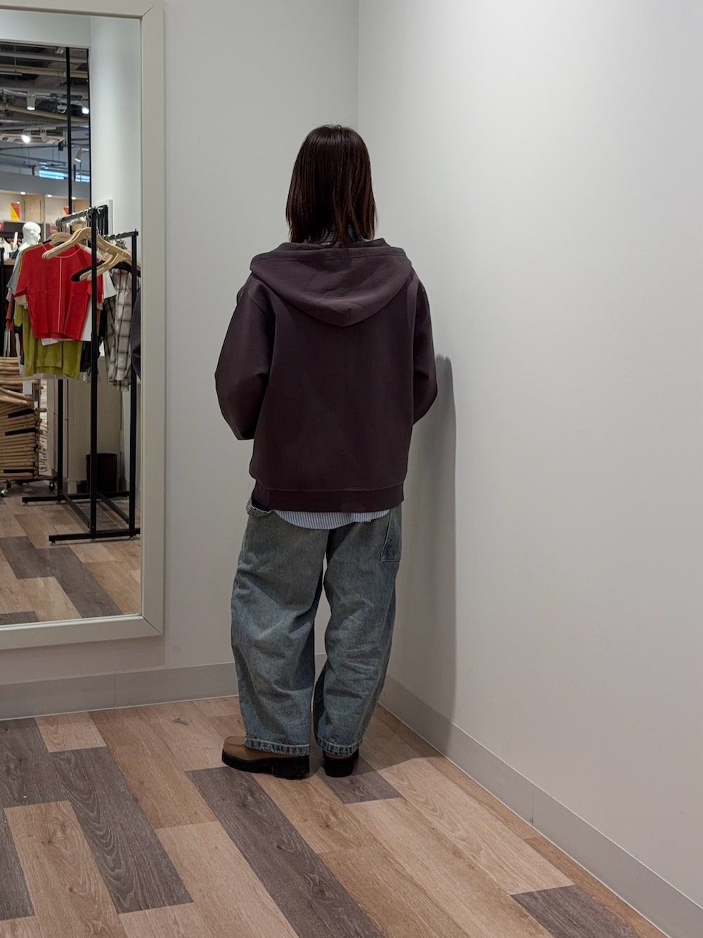 ブラウン系のパーカー、ブルー系のシャツ/ブラウス、ブルー系のデニムパンツを着用したレディースの春コーディネートの3枚目の写真