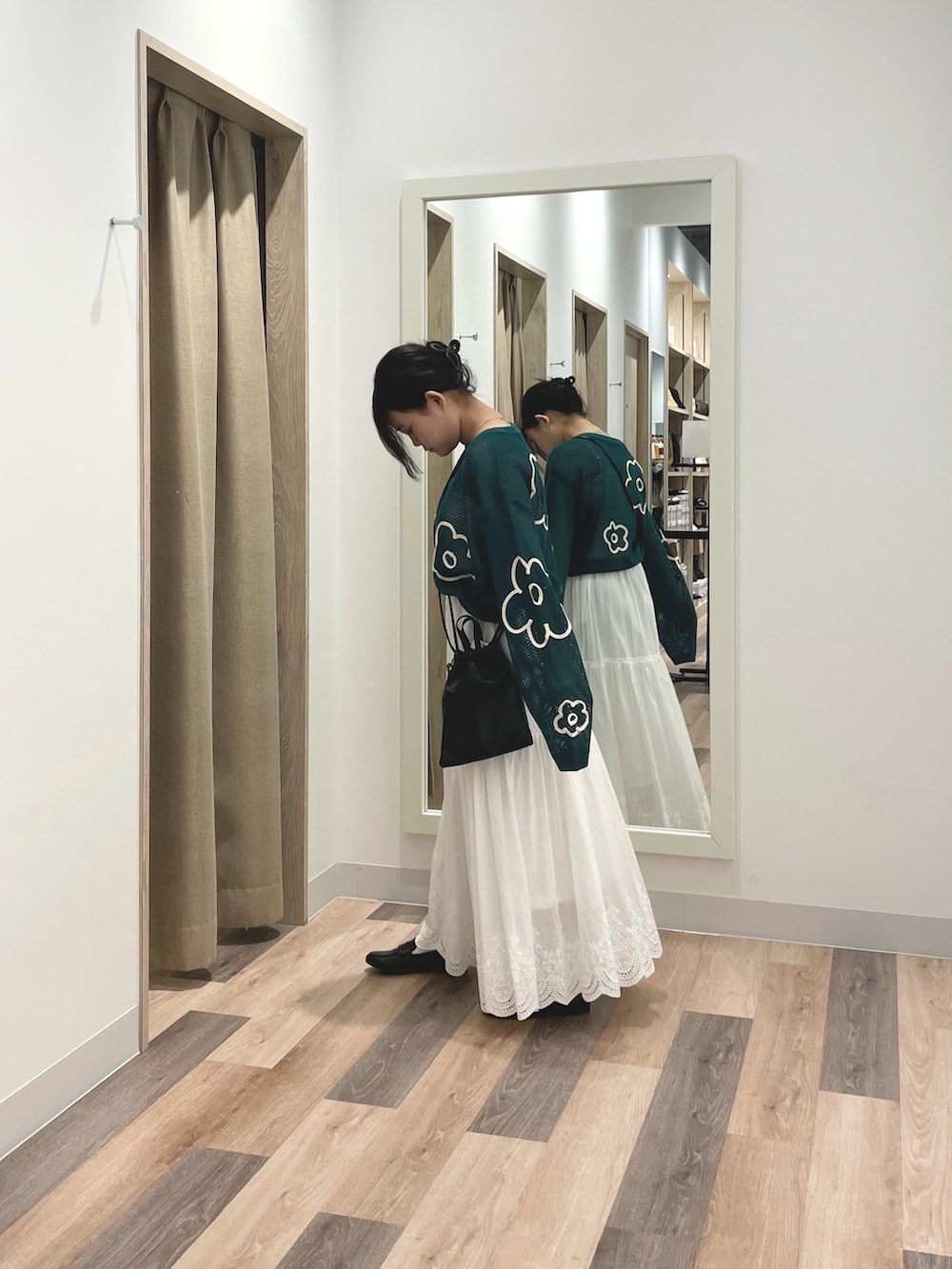 グリーン系のニット/セーター、ブラック系のショルダーバッグ、ブラック系のローファーを着用したレディースの春コーディネートの2枚目の写真