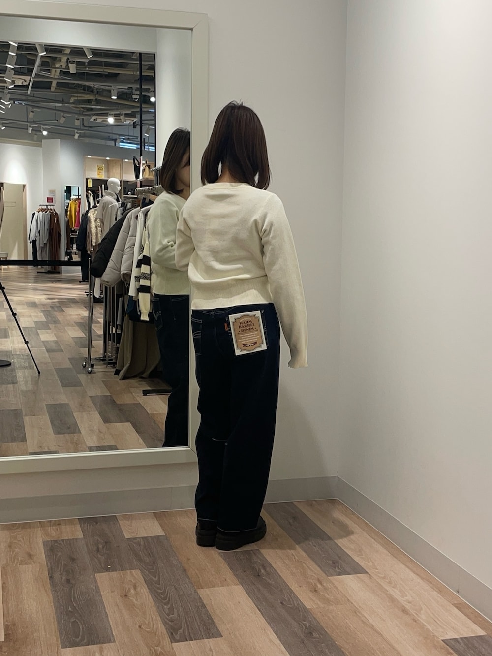 ホワイト系のカーディガン/ボレロ、ブルー系のデニムパンツを着用したレディースの冬コーディネートの3枚目の写真