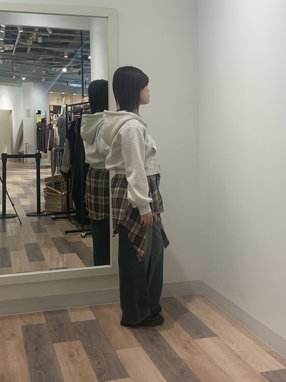 グレー系のパーカー、ブルー系のデニムパンツを着用したレディースの冬コーディネートの2枚目の写真