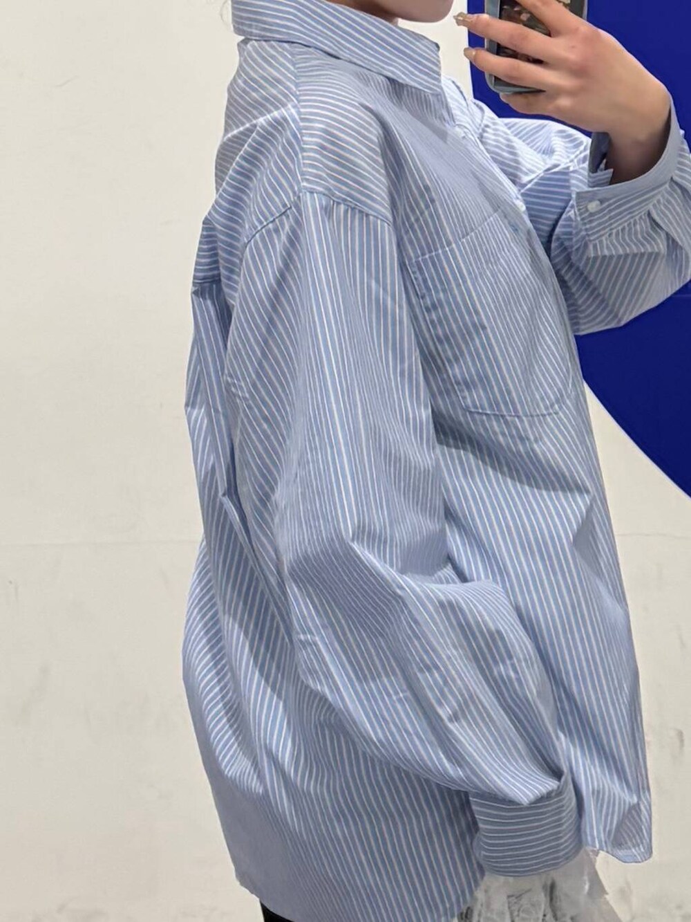 ホワイト系のその他パンツ、ブルー系のシャツ/ブラウス、ブラック系のブーツを着用したレディースの冬コーディネートの3枚目の写真