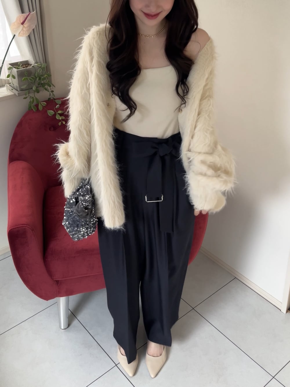 ベージュ系のカーディガン/ボレロ、グレー系のスラックスを着用したレディースの冬コーディネートの3枚目の写真