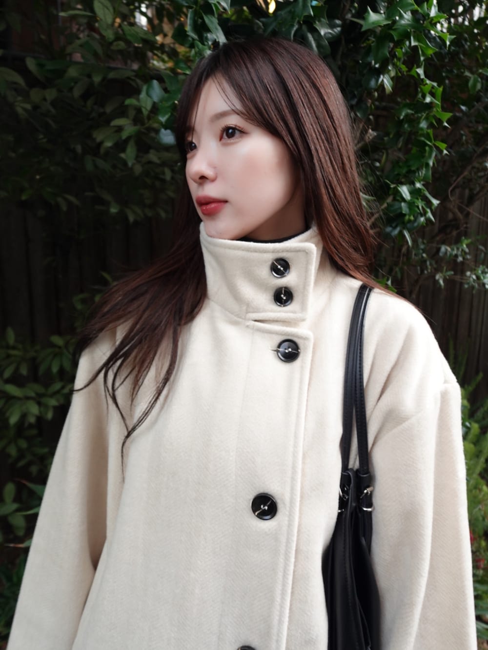 ホワイト系のその他アウター、ブラック系のショルダーバッグを着用したレディースの冬コーディネートの5枚目の写真