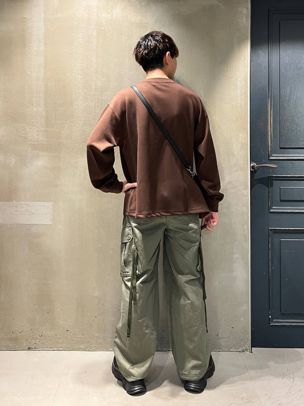 グリーン系のカーゴパンツ、ブラック系のショルダーバッグ、ブラック系のローファーを着用したメンズの夏コーディネートの7枚目の写真