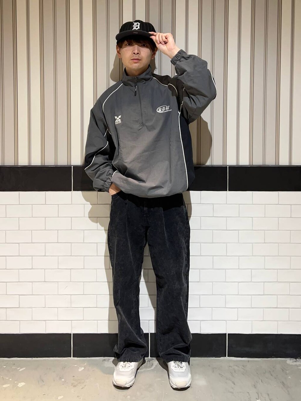 グレー系のスニーカー、グレー系のスウェット、ブラック系のキャップを着用したメンズの秋コーディネートの4枚目の写真