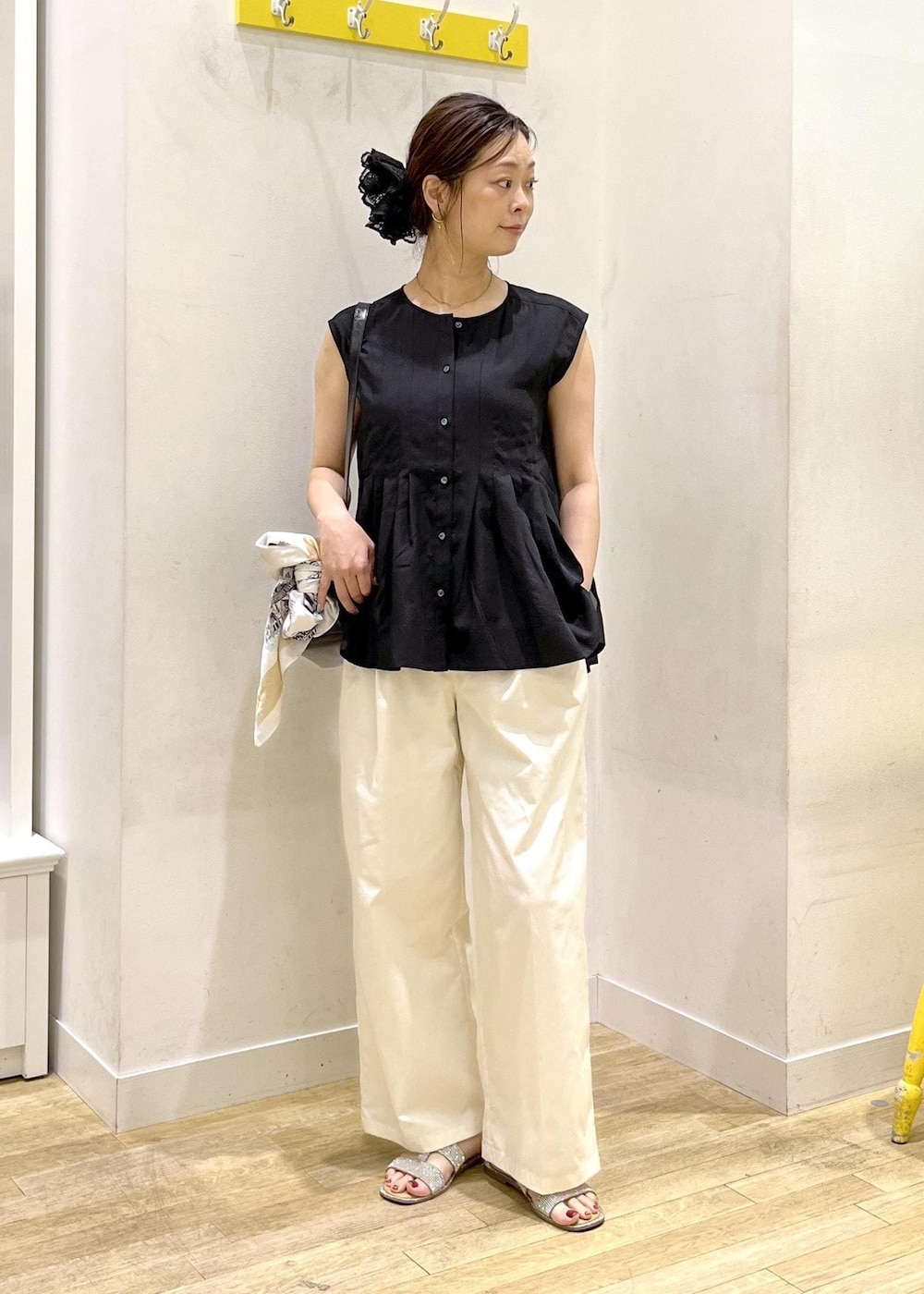 ホワイト系のチノパンツ、ブラック系のシャツ/ブラウスを着用したレディースの夏コーディネートの2枚目の写真