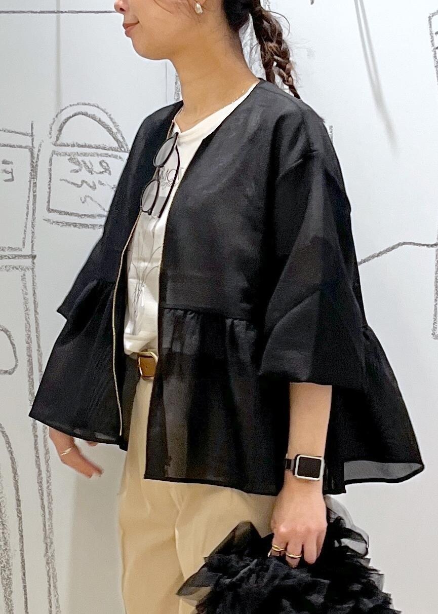 ブラック系のショルダーバッグ、ベージュ系のチノパンツ、ブラック系のブルゾンを着用したレディースの春コーディネートの7枚目の写真