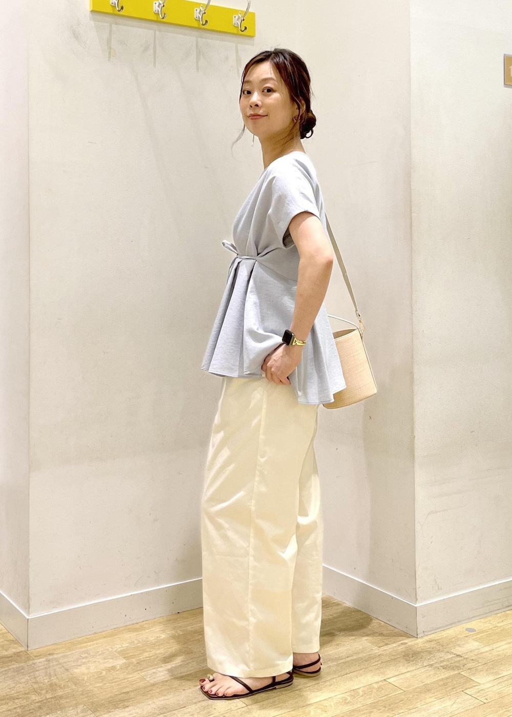 ブルー系のシャツ/ブラウス、ホワイト系のチノパンツ、ホワイト系のハンドバッグを着用したレディースの夏コーディネートの4枚目の写真