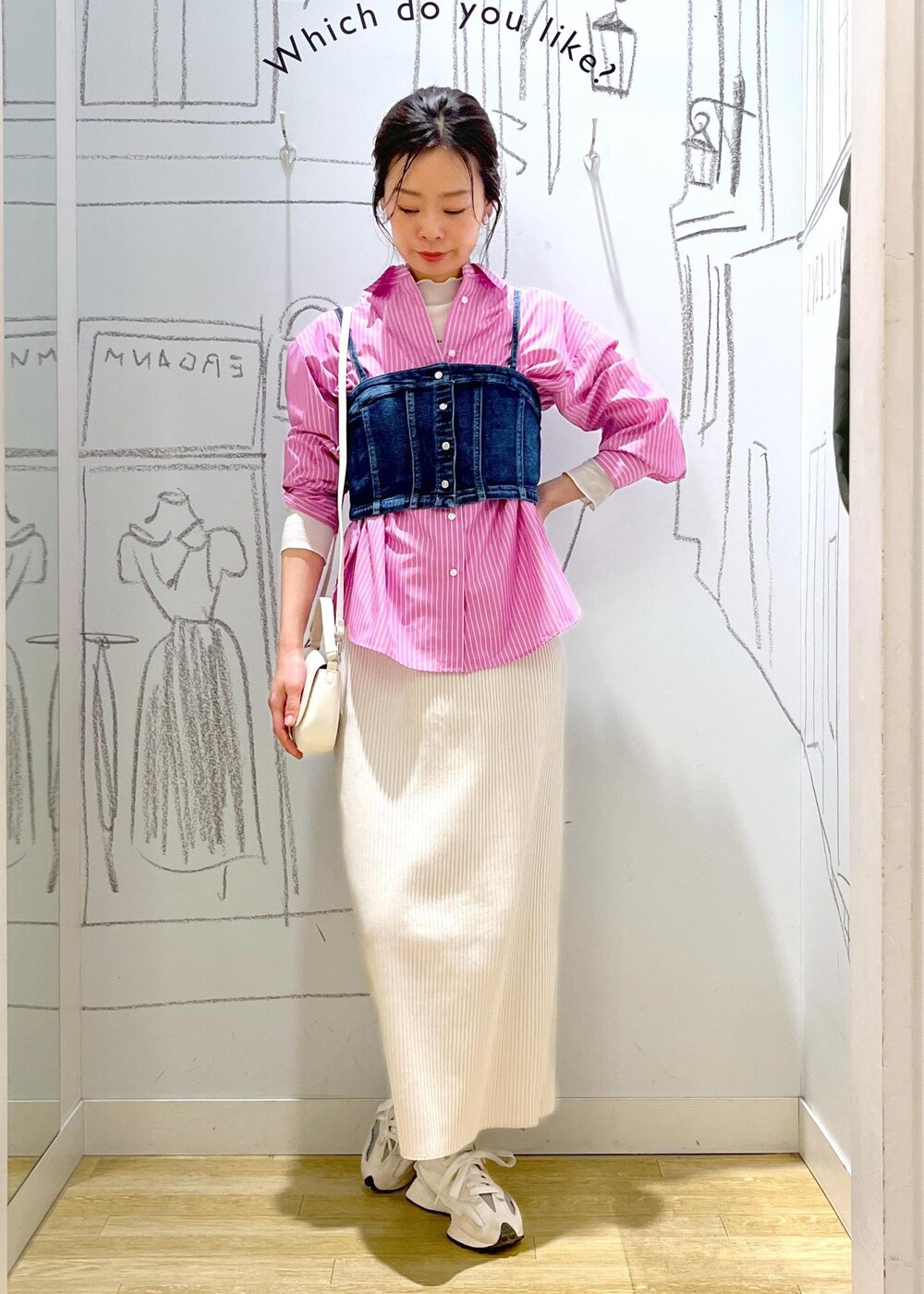 グレー系のスカート、ブルー系のベスト、ピンク系のシャツ/ブラウスを着用したレディースの春コーディネートの2枚目の写真