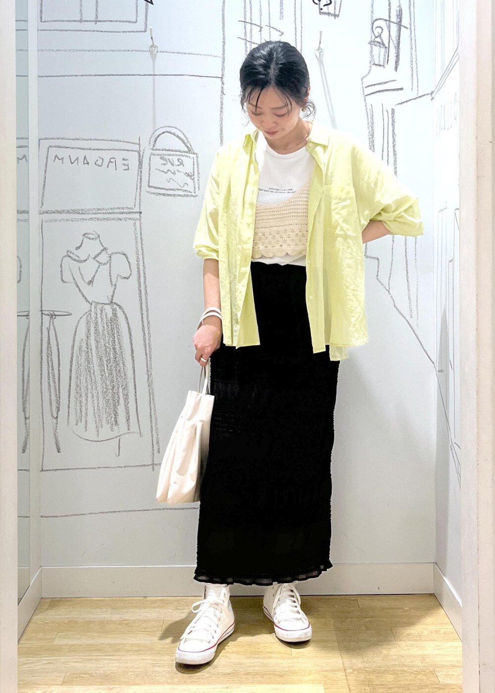 イエロー系のシャツ/ブラウス、ホワイト系のトートバッグ、グレー系のスカートを着用したレディースの春コーディネートの5枚目の写真
