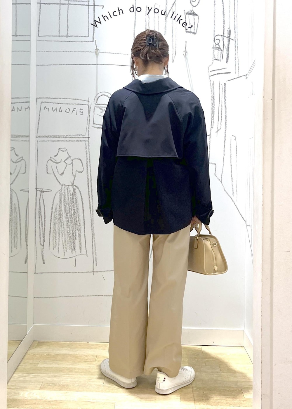 ベージュ系のボストンバッグ、ホワイト系のスウェット、ベージュ系のチノパンツを着用したレディースの春コーディネートの4枚目の写真